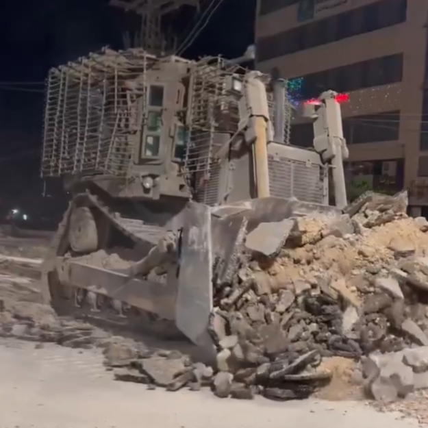 An IDF bulldozer checks for explosive charges beneath roads approaching the Nur Shams camp near Tulkarem (Screenshot)